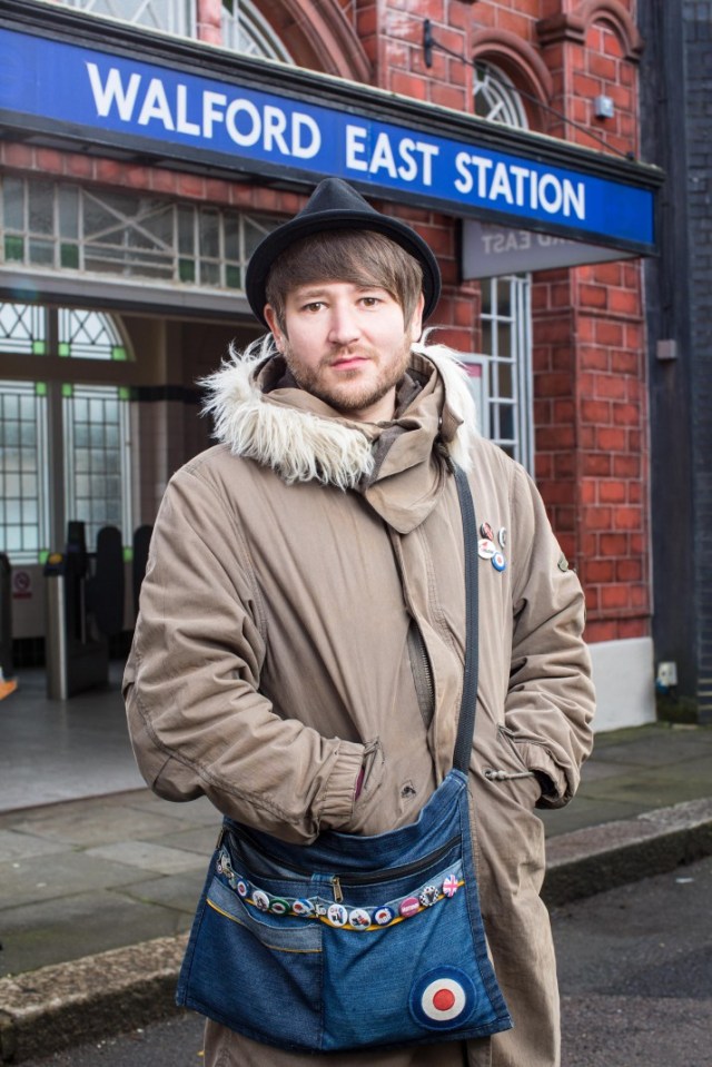 Ben Champniss, who plays Shrimpy in EastEnders, standing outside Walford East station.