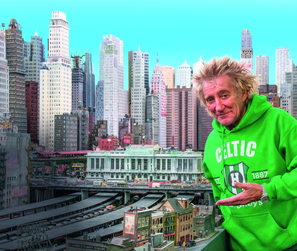 Rod Stewart with his extensive model railway, depicting a cityscape.