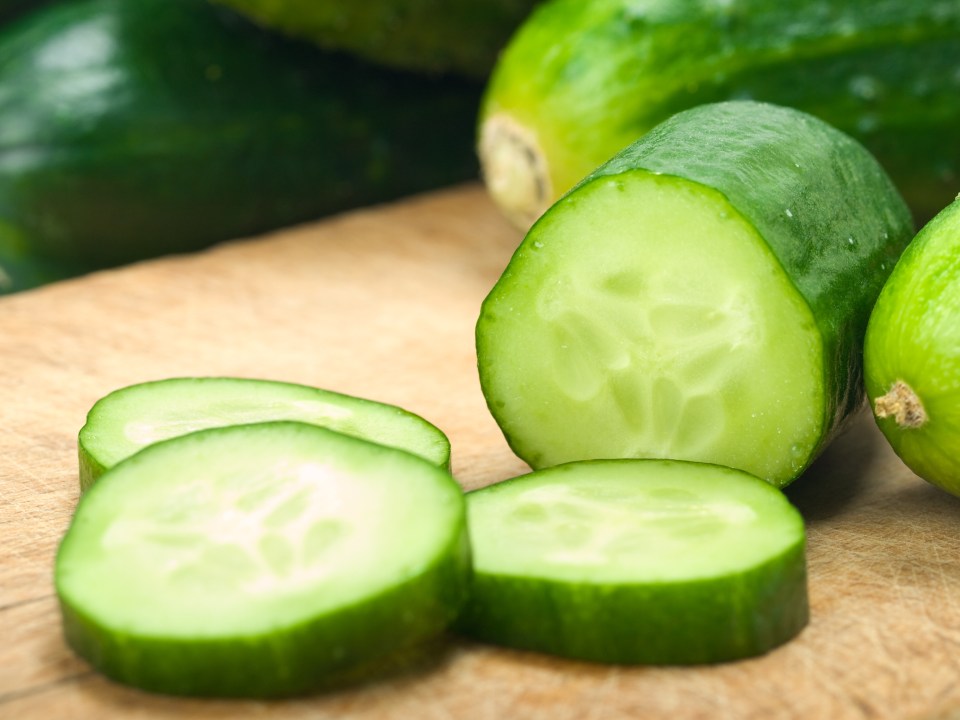 Sliced cucumbers on a cutting board.