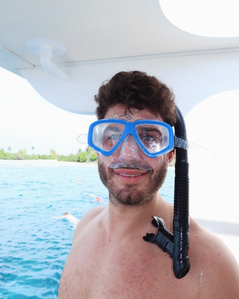 Man wearing a snorkeling mask and snorkel.