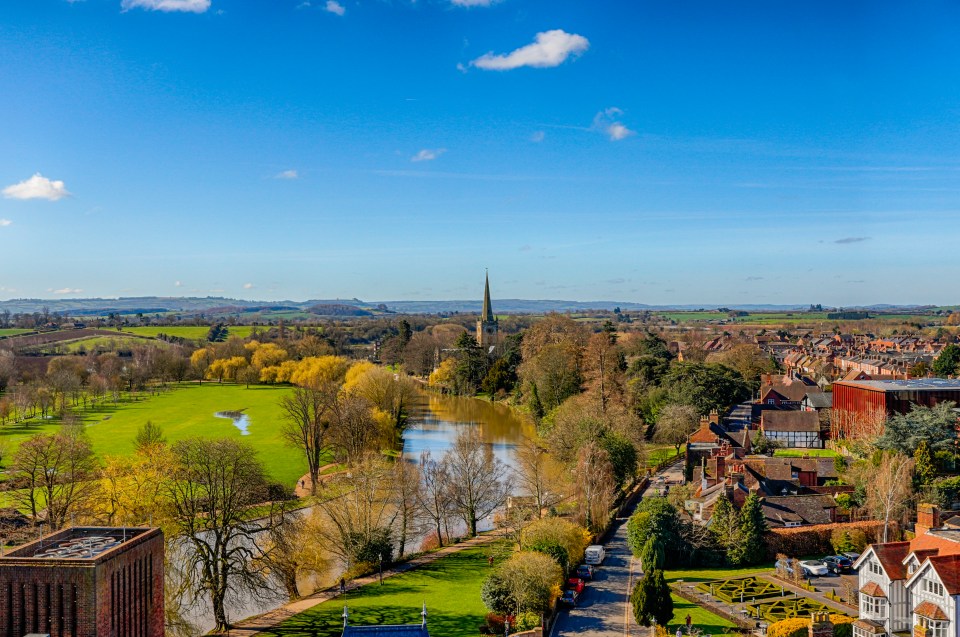 Aerial view of Stratford-upon-Avon, England, showing the River Avon, Trinity Church, and surrounding town.