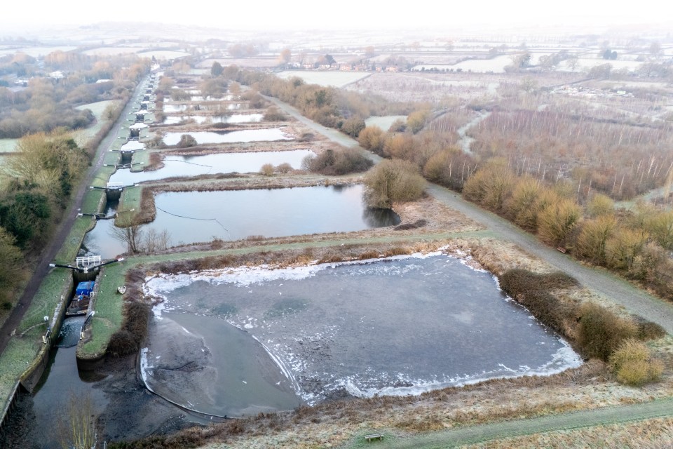 Aerial view of Caen Hill Locks with ice forming on the water.