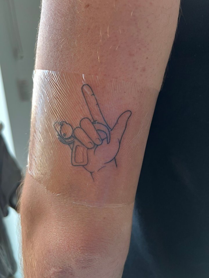 New tattoo of a hand making the "I love you" sign in sign language.