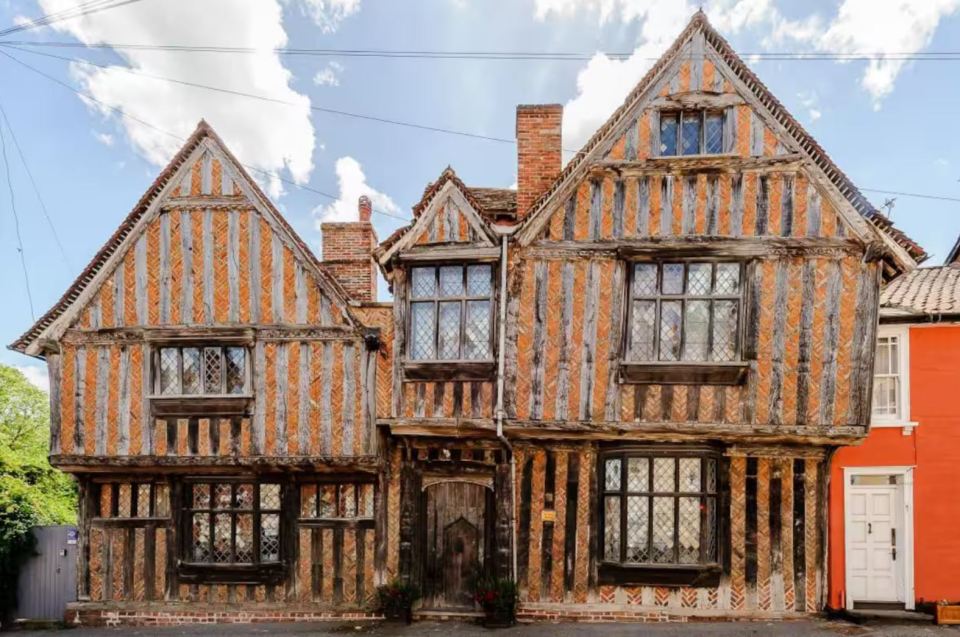 De Vere House, a timber-framed building with orange and brown wood.