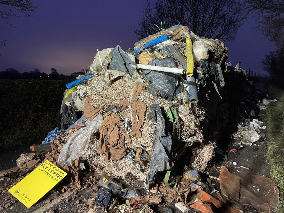 Ten-foot-high pile of fly-tipped building waste.