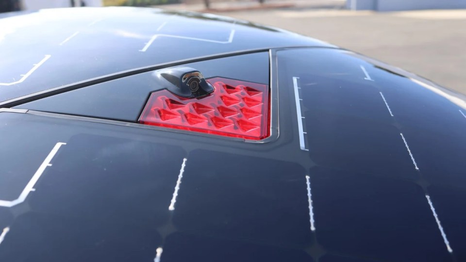 Solar-powered three-wheeled car's rear camera and taillight.