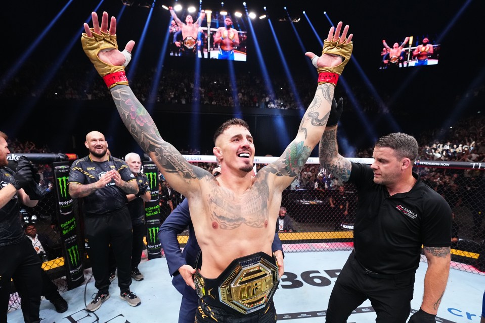 Tom Aspinall celebrates his UFC interim heavyweight championship victory.