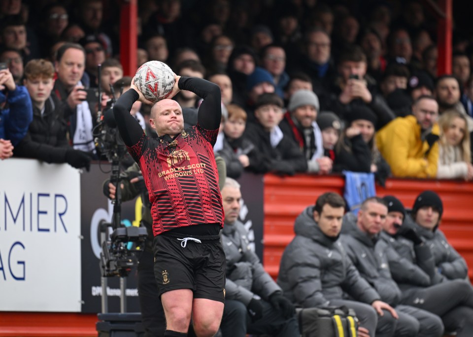 Tom Tonks of Tamworth prepares to throw the ball during a soccer match.