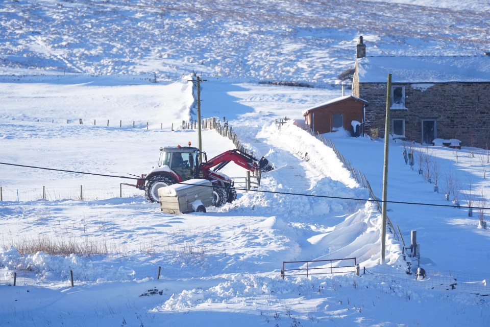 A tractor helps clears paths in Northumberland on Tuesday