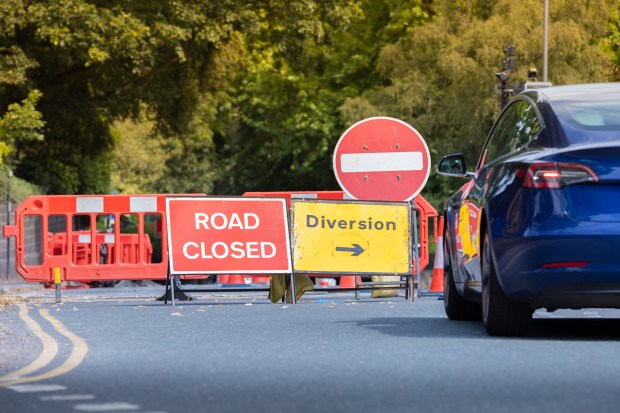 Road closed sign with detour information.