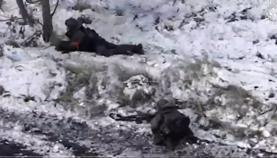 Ukrainian soldiers in a snowy trench.