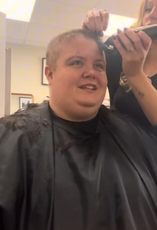 Woman having her head shaved.