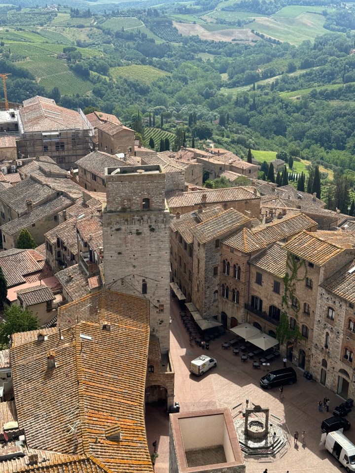 Aerial view of Tuscan town square and surrounding countryside.