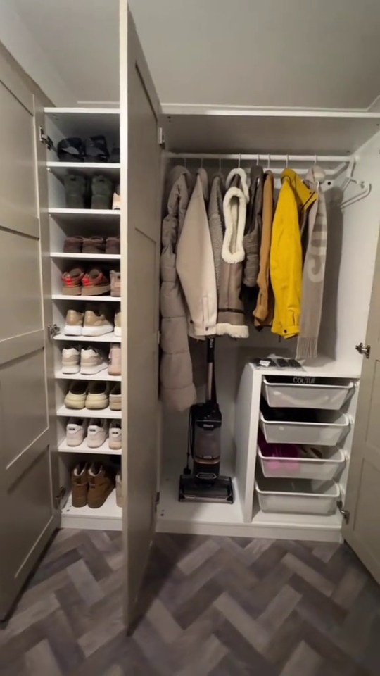 Walk-in wardrobe with shoes, coats, and storage.