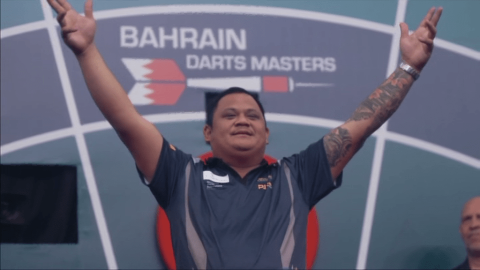 Darts player celebrating victory at the Bahrain Darts Masters.