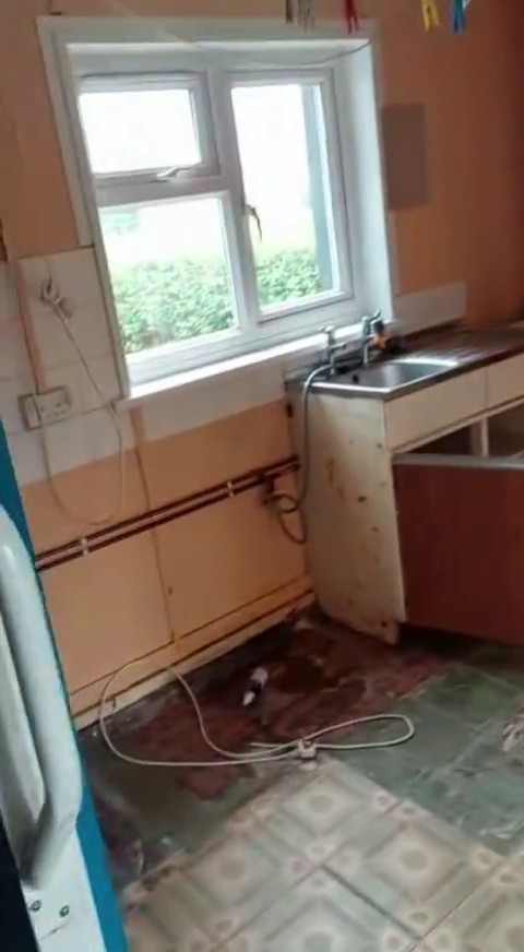 Damaged kitchen in a council house.