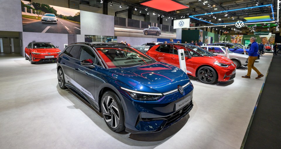 Volkswagen ID.7 Tourer and ID.3 electric cars on display at a car show.