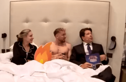 Zara McDermott, Sam Thompson, and Michael McIntyre in bed.