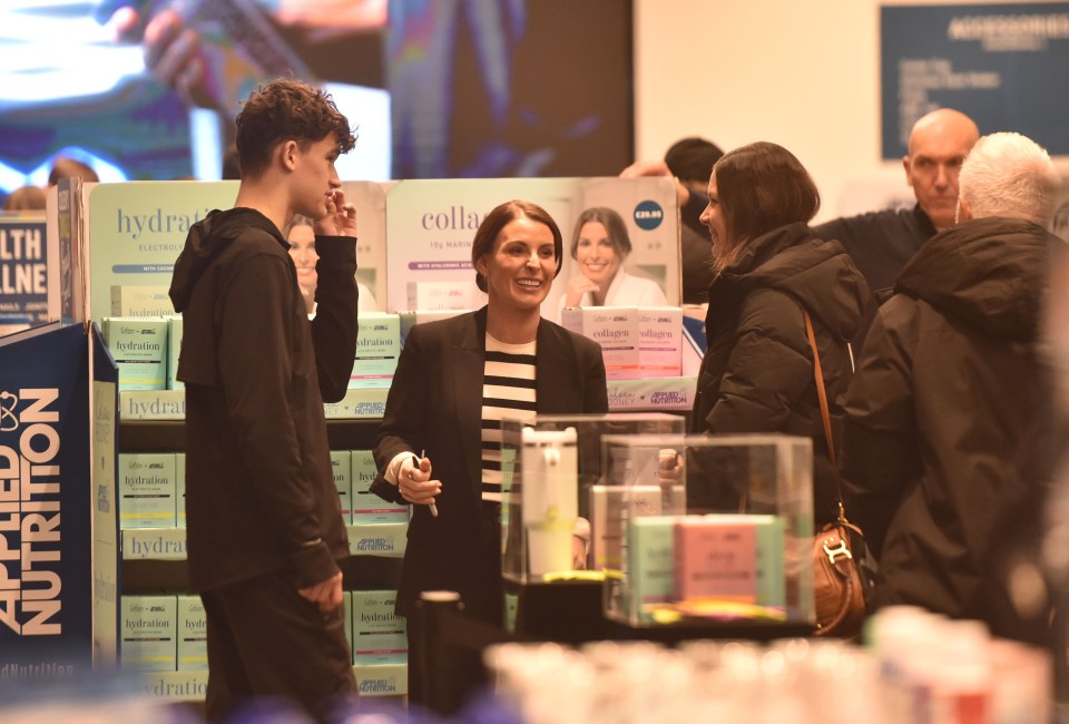 Wayne Rooney supporting his wife Coleen at the launch of her health and wellness product line.