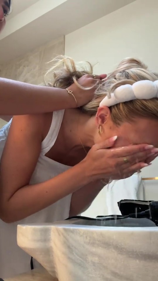 Bride washing off makeup before her wedding.