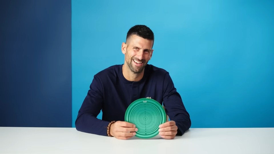 Novak Djokovic holding a green disc.