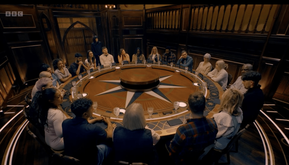 A group of people seated around a large circular table.