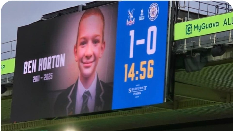 Memorial for Ben Horton (2011-2025) displayed on a stadium scoreboard.