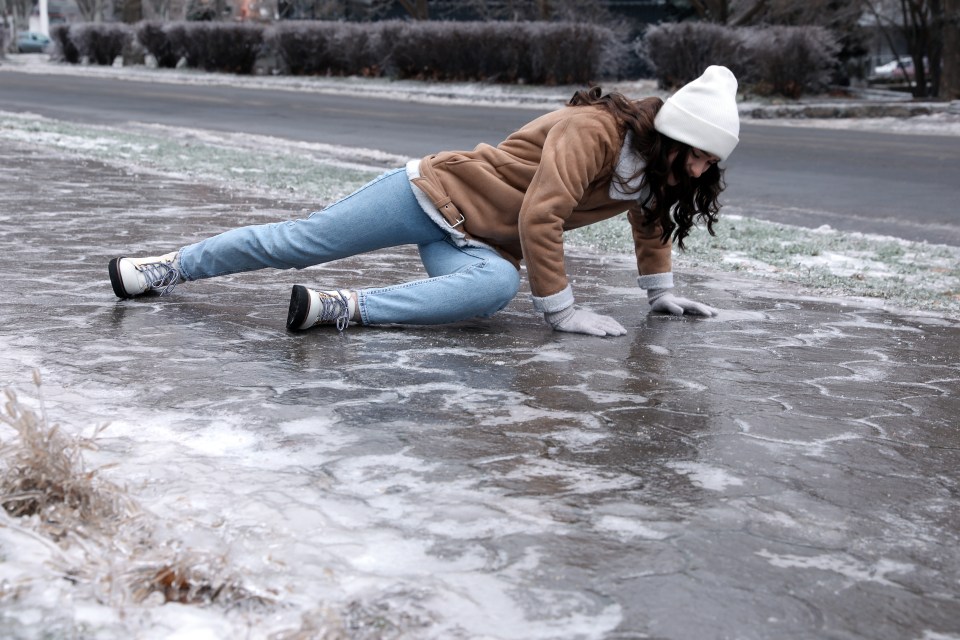 Woman fallen on icy pavement.